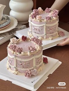 two pink wedding cakes with flowers on them