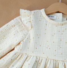 Girls dress made of 100% cotton. Long sleeve. Muslin fabric. Double gauze with golden dots. In photos you can see beige color dress. Available in white and burgundy too. All items are handmade and unique, therefore pattern placements may vary slightly from the item pictured. You can buy the same color headband here https://www.etsy.com/uk/listing/871506857/organic-linen-hair-bow-for-girl-or-baby?ref=shop_home_active_10 Sizing Guidelines (runs big and fits better on a maximum age range indicated, Flower Girl Toddler, Cotton Baby Dress, 1st Birthday Outfit, Long Sleeve Cotton Dress, First Birthday Dresses, Baptism Dress, Christening Dress, 1st Birthday Outfits, Girl Toddler