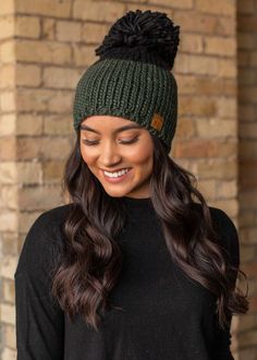 Hunter green and black color block fleece lined knit hat with large pom accent. Green Soft Knit Hat For Cold Weather, Cozy Green Winter Hat, Winter Green Soft Knit Hat, Green Soft Knit Winter Hat, Winter Soft Knit Green Hat, Green Winter Hat For Cold Weather, Cozy Green Hat For Fall, Cozy Green Fall Hats, Cozy Green Hat One Size Fits Most