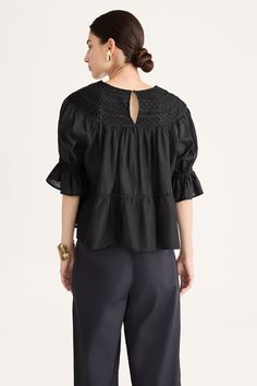 Our classic SOL blouse, re-imagined for Collection 14. Featuring rows of cross-shaped and herringbone-pattern engineered eyelets at the yoke. Crochet trim delineates the tiers in the body, and the sleeves have an elasticated, ruffled cuff. The SOL has a voluminous silhouette and is best worn loose over form-fitting pants like the SARGENT or LEON pants. Crafted in smooth 100% Pima cotton lawn that has a slight sheen. Voluminous fit. True to size in the shoulders and yoke.