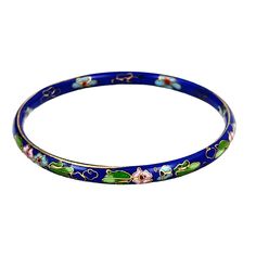 This beautiful vintage bangle bracelet showcases exquisite cloisonné craftsmanship. The intricate enamel inlay features delicate green and pink flowers against a deep blue background. Its elegant design is perfect for adding a touch of sophistication to any outfit. With a comfortable 2.75" diameter, it fits most wrist sizes. * Vintage cloisonné bangle * Enamel floral design * Blue, green & pink colors * 2.75" diameter * Lightweight and comfortable Features: * Gift for Her, Retro, Chinese Export Size: Womens 2.5" interior opening Traditional Blue Flower Jewelry, Blue Enamel Bangle Gift, Blue Enamel Bracelet For Gift, Blue Enamel Bangle As A Gift, Blue Enamel Bangle Perfect As A Gift, Vintage Blue Enamel Bracelets, Blue Enamel Bangle Bracelets, Blue Enamel Bangle, Blue Enamel Bangle Bracelet