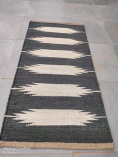 a black and white rug on the ground