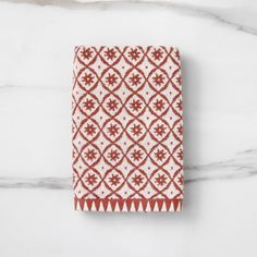 a red and white towel on a marble surface