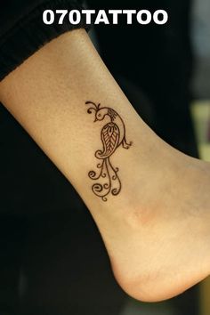 a woman's foot with a tattoo on it