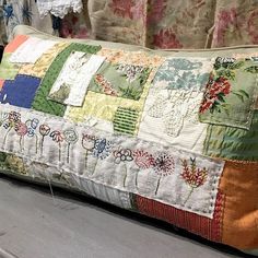 a patchwork pillow sitting on top of a wooden table