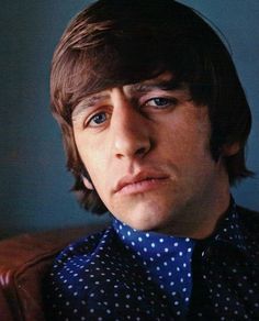 a close up of a person wearing a shirt and tie with polka dots on it