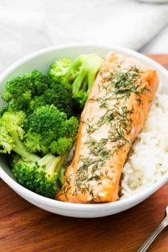 a bowl filled with rice, broccoli and salmon