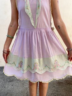 Vintage 1930s Lavender Pinafore Dress. Soft lavender cotton voile apron style dress. Has a scallop and embroidered v-neckline and lace trim details. Ribbon ties at sides for easy on and off. 100% cotton, handwash cold. No marked size, fit is approximate S/M. Approx. Measurements Waist: 16” Length: 41” Lavender Cotton Dress With Ruffles, Lavender Cotton Dress For Garden Party, Vintage Lavender Dress For Daywear, Lavender Cotton Daywear Dress, Lavender Cotton, Ryan Roche, Soft Lavender, Ace And Jig, Raquel Allegra