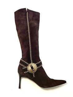 These vintage Casadei boots have a subtle western style, with whipstitch detailing and a brass medallion at the ankle.  Knee high Pointed toe Side zip Suede upper, leather sole Size 10U.S. (run small, recommend for 9-9.5) Shaft: 11in. (27.94cm.) Heel: 3.14in. (8cm.) Shoe bed/insole length: 13in. (33.02cm.) -the first few inches are too narrow for toes.  Width at ball of foot: 3.2in. (8.12cm.) Made in Italy  These boots are in very good condition: only sign of wear is to the soles. Condition Char Vintage Formal Boots With Buckle Closure, Casadei Boots, Brown Suede Boots, Cowboy Western, Western Cowboy Boots, Western Style, Suede Boots, Brown Suede, Western Boots