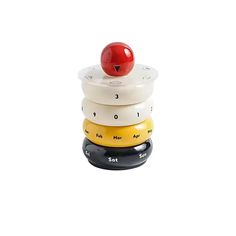 a stack of four ceramic clocks with a cherry on top, all stacked up together