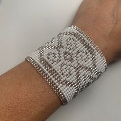 Beautiful white and silver beaded goddess medicine cuff. My favorite!adjustable to fit 3 sizes. cuff is 6”(15.25cm) long, plus the clasps make it 8”. smallest adjustment is 7” around the wrist and larger is 8”Handmade with glass seed beads. Adjustable Silver Beads Cuff Bracelet As Gift, Adjustable Cuff Bracelet With Silver Beads As A Gift, Silver Beaded Cuff Bracelet For Festival, Adjustable Beaded Cuff Bracelet Bangle, Adjustable Cuff Beaded Bracelets For Festival, Adjustable Bohemian Cuff Bracelet With Large Beads, Silver Beaded Stretch Bracelet For Festivals, Bohemian Adjustable Cuff Bracelet With Large Beads, Beaded Cuff Bracelet For Festivals