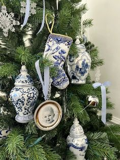 a christmas tree decorated with blue and white china ornaments, ornaments and an ornament