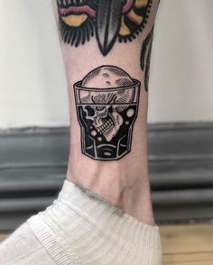 a person's foot with a tattoo on it and a skull in the middle