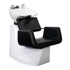 a white sink sitting next to a black chair on top of a counter in front of a faucet