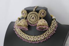 * Necklace Length - 14 -16 inches adjustable * Necklace Width - 1.2 Inch * Earrings Length - 1.7 inches * Earrings Width -0.4 inches **Simi Lavender Polki Choker Necklace** Elevate your elegance with the Simi Lavender Polki Choker Necklace, a masterpiece of Indian jewelry craftsmanship. This exquisite piece blends traditional charm with contemporary sophistication, making it a standout accessory for any occasion. **Design and Craftsmanship. - **Lavender Hues Adorned with delicate lavender-colored stones, this choker introduces a serene and graceful tone to your ensemble, perfectly complementing a variety of outfits. - **Intricate Setting Handcrafted with meticulous attention to detail, the necklace boasts an intricate setting that highlights the faux Polki and enhances their brilliance. ** Choker Necklace Indian, Punjabi Jewelry, Polki Choker, Indian Choker, Indian Choker Necklace, Jewelry Kundan, Women Jewellery, Necklace Indian, Kundan Necklace