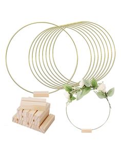 four pieces of wood with flowers and leaves on them next to a piece of wire