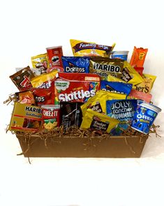 a box filled with lots of different types of candy and snacks on top of it