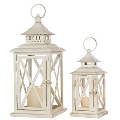 two white wooden lanterns with candle holders on each side and one light in the middle