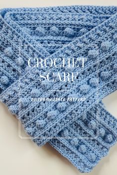 a blue crochet scarf with the words, keep warm and cook great