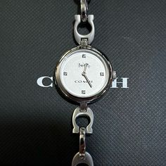 Enjoy V Beautifil Coach Watch With 26mm Silver Face With Silver Hands & Crystals On Its Hourmarkers & Coach Signature "C" Silver Chain Bracelet. It's Original Retail Price Is $275 & Overheads. Enjoy This Gorgeous & Unique Timepiece At Great Discounted Price. Timeless Silver Coach Jewelry, Timeless Coach Jewelry For Gift, Elegant Silver Coach Watch, Elegant Coach Jewelry With Polished Finish, Silver Coach Bracelets For Formal Occasions, Coach Silver Bracelets For Formal Occasions, Coach Silver Jewelry For Formal Occasion, Formal Silver Coach Jewelry, Coach Silver Jewelry