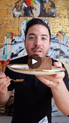 a man holding a plate with food on it