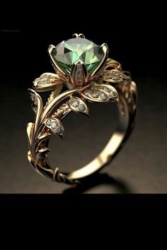 a green ring with leaves and diamonds on it's sides, sitting on a black surface