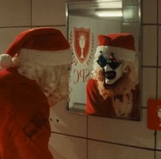 a person wearing a santa claus hat looking in a mirror