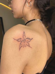 a woman with a flower tattoo on her back