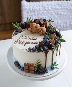 there is a cake with chocolate and berries on it