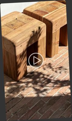 three wooden benches sitting on top of a brick floor