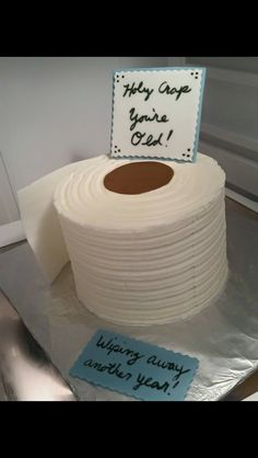 a roll of toilet paper sitting on top of a cake