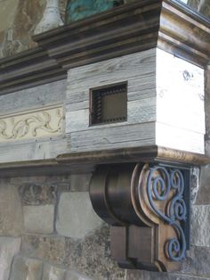 a close up of a clock on the side of a stone building with decorative designs