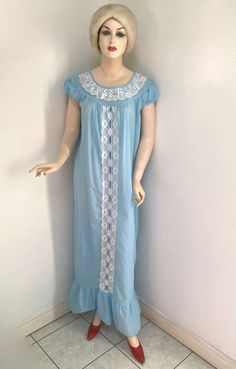 "Vintage 1960s/1970's ADORABLE NIGHTGOWN by SLUMBER SUZY DREAMWEAR in size MEDIUM.  Made in CANADA of 65% polyester and 35% cotton (exclusive of trimming), it is blue with white lace trims and a darker blue ribbon woven down through the lace down the front.  It has capped short sleeves and a ruffled bottom and is in excellent wearable vintage condition. Laying flat it measures: 16\" from shoulder to shoulder 3.5\" from shoulder to cuff  21\" across the bust  23\" across the waist 23.5\" across t Ugly Holiday Sweater, Vintage Aloha, Fabulous Furs, Velvet Coat, Women's Nightgowns, Holiday Sweater, Lace Trims, Blue Ribbon, Vintage 1960s