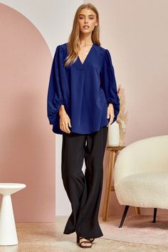 Blue is the color of the sky and sea, and in this blouse it’s the color of confidence. With a flowing silhouette and 3⁄4 sleeves that billow with carefree spirit, the Be Yourself top invites you to embrace your true self. Made for turning heads with every flutter of its fluid bodice, this ravishing royal blue top is a sartorial reminder that style knows no limits. Pair it with white denim for a nautical vibe or a boldly printed bottoms to really make a statement. However you style it, one thing’ Versatile Blouse For Brunch, Billowy Blouse With Gathered Sleeves For Brunch, Flowy Lantern Sleeve Blouse For Brunch, Blue Tops With Gathered Sleeves For Work, Oversized Blue Blouse For Work, Flowy Tops With Blouson Lantern Sleeves, Brunch Blouse With Blouson Sleeves, Versatile Flowy Long Sleeve Blouse, Brunch Blouse With Balloon Sleeves