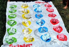 a child is sitting in front of a table covered with plastic cups and napkins