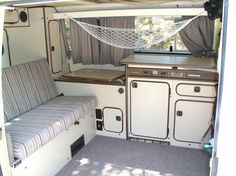 the inside of a camper with two couches and an oven