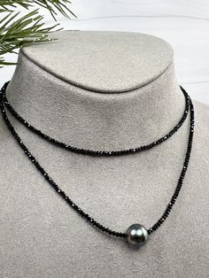 Tiny 1-2mm faceted Black Spinel sparkle along this pretty necklace, accented with a lovely Tahitian Pearl in the center. The Tahitian Pearl has beautiful luster with overtones of purple & green. A wonderful combination between the sparkles of the spinel and luster of the Tahitian Pearl. The necklace measures 16 with a 2" extender and is finished off with a lobster clasp and dangle of gold filled beads. Tahitian pearl measures 10mm. Each pearl is one of a kind with variations in color, shape & lu Elegant Faceted Round Bead Gemstones, Elegant Rondelle Pearl Necklace With Faceted Beads, Elegant Pearl Necklace With Faceted Rondelle Beads, Elegant Double Strand Crystal Necklace With Faceted Beads, Elegant Faceted Rondelle Pearl Necklace, Elegant Rondelle Jewelry With Faceted Beads, Elegant Jewelry With Faceted Rondelle Beads, Elegant Briolette Jewelry With Faceted Beads, Elegant Crystal Necklace With Faceted Beads