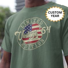 a man wearing a green shirt with an american flag on it