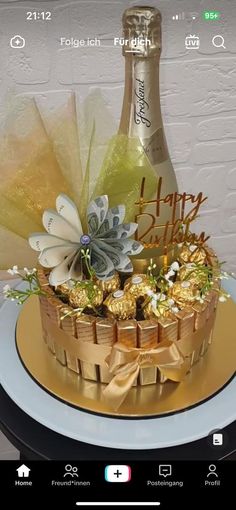 a champagne bottle and some chocolates in a basket on top of a table with a plate