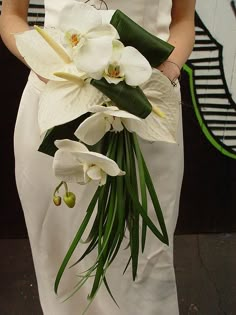 a woman holding a bouquet of flowers on her wedding day is seen on instagram