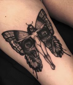 a woman with a butterfly tattoo on her thigh