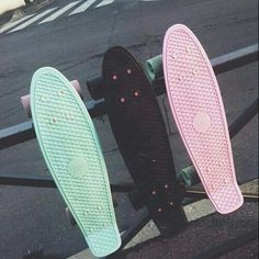 two skateboards sitting on top of a metal rail