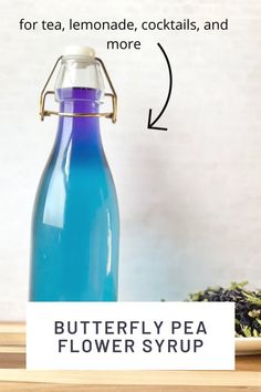 a blue bottle sitting on top of a wooden table