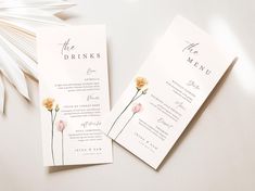 two wedding menu cards with flowers on them