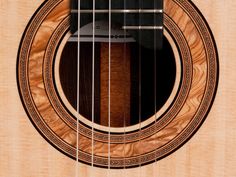 an acoustic guitar is shown with the fret inlayed to it's body