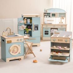 an assortment of toy kitchen furniture in a playroom