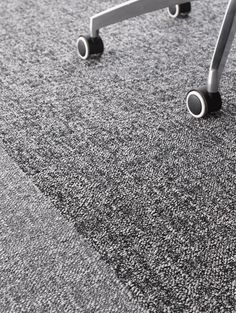 an office chair sitting on top of a carpet covered floor