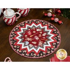 a red and black christmas decoration with candy canes on the table next to it