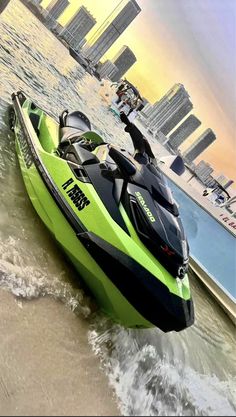 a green and black jet ski is in the water