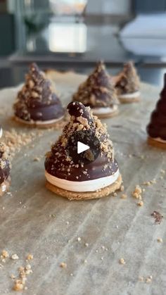 chocolate covered cookies are sitting on top of a baking sheet and sprinkled with crumbs